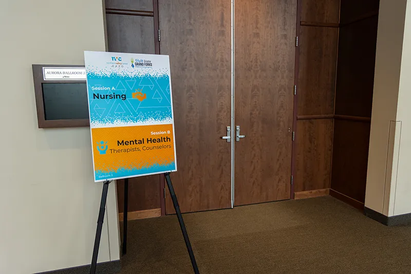 A sign on a stand for the Northern Valley Career Expo indicating the session titles.